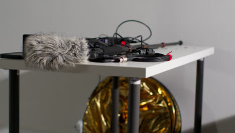 Close-Up-Of-Film-Sound-Recording-Equipment-With-Microphone-Boom-Pole-And-Wind-Muff-Shooting-Movie-Or-Video-In-Studio